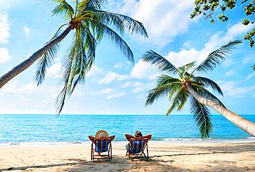 Couple relax on the beach enjoy beautiful sea on the tropical island. Summer beach vacation concept