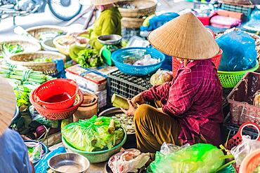 Women selling food on the street of Hoi An in Quang Nam Province, Vietnam, Asia