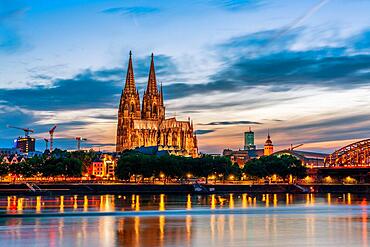 Panoramic view of Cologne Cathedral with Hohenzollern Bridge at nightfall, Germany, Europe