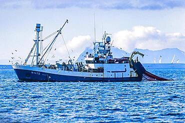 Russian Shrimp trawlers fishing in arctic waters outside a rocky coast, Svalbard, Norway, Europe