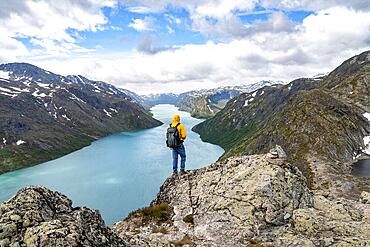 View of Lake Gjende and mountains, mountaineers on Besseggen hike, ridge walk, Jotunheimen National Park, Vaga, Innlandet, Norway, Europe