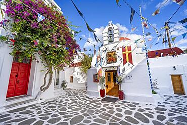 Cycladic Greek Orthodox Church decorated with flags, alleys of the old town Chora, Mykonos Town, Mykonos, Cyclades, Greece, Europe