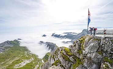 Mountaineers at the summit of Saentis, mountain peak above the sea of clouds, high fog in the valley, Saentis, Appenzell Ausserrhoden, Appenzell Alps, Switzerland, Europe