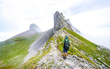 Mountaineer at Hoech-Niederi Sattel, rocky ridge, Saentis, Appenzell Ausserrhoden, Appenzell Alps, Switzerland, Europe