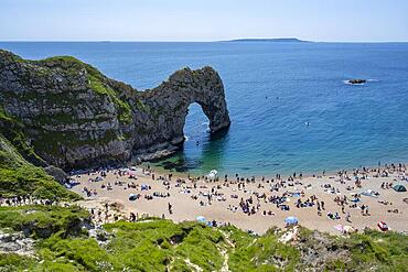 Bathing beach at the famous rock bridge Durdledoor, West Lulworth, Dorset, England Great Britain