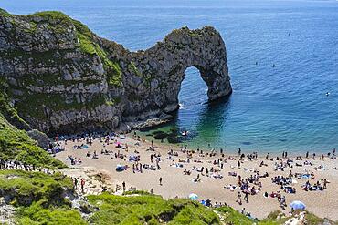 Bathing beach at the famous rock bridge Durdledoor, West Lulworth, Dorset, England Great Britain