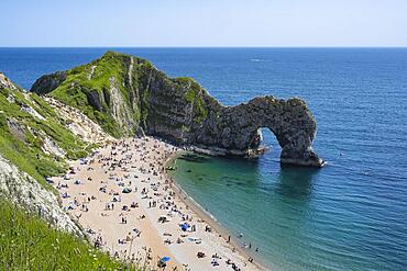 Bathing beach at the famous rock bridge Durdledoor, West Lulworth, Dorset, England Great Britain