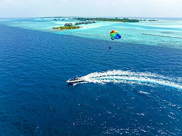 Aerial View, Maldives, North Male Atoll, Paraglider at Paradise Island with Water Bungalows, Asia