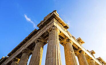 View of corner of Parthenon and its columns on Acropolis in Athens, Greece against blue sky upshot