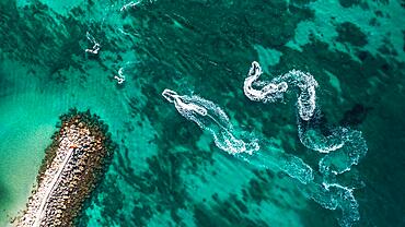 Aerial view on motorboat and jetski on the sea surface