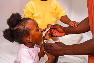 African black ethnic family father with his children in the room of his house eating