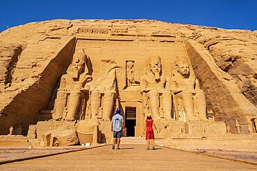 A tourist couple visiting the Abu Simbel Temple in southern Egypt in Nubia next to Lake Nasser. Temple of Pharaoh Ramses II, travel lifestyle