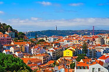 Lisbon famous view from Miradouro dos Barros tourist viewpoint over Alfama old city district, 25th of April Bridge and Christ the King statue. Lisbon, Portugal, Europe