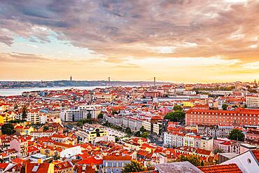 View of Lisbon famous view from Miradouro da Senhora do Monte tourist viewpoint of Alfama and Mauraria old city district, 25th of April Bridge at sunset. Lisbon, Portugal, Europe