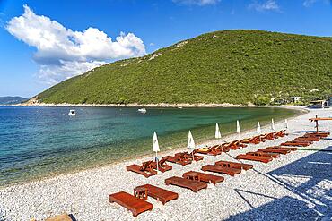 Sunbeds on the beach in the village of Zanjice, Lustica Peninsula, Montenegro, Europe