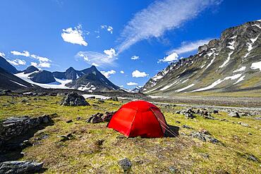 Red tent in Kaskasavagge valley, Kaskapakte glacier and mountains, mountain Kaskasatjakka and Kuopertjakka, river Gaskkasjohka, Kebnekaise massif, Lapland, Sweden, Europe