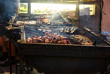 Fish and meat on a grill of a restaurant in the old town of Lisbon, Portugal, Europe