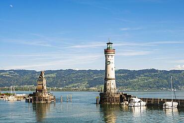 Harbour entrance of Lindau at Lake Constance with lighthouse and mountains, Germany, Europe