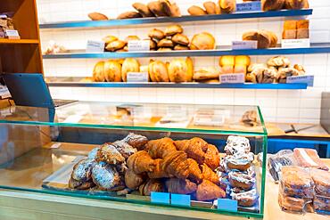 Bakery in the workshop workshop of artisan bakery and shop placing croissant and neapolitan