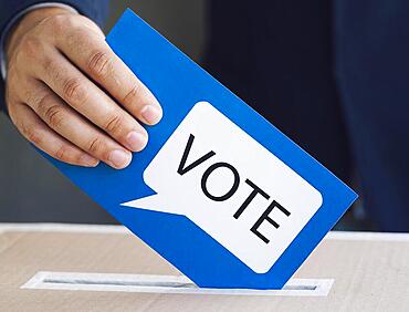 Person putting ballot election box