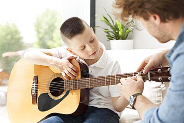 Tutor boy playing guitar