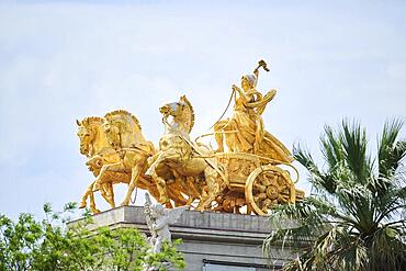 Golden sculpture of a chariot driver with three horses pulling the chariot, Barcelona, Spain, Europe