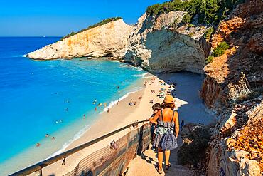 Woman walking down the stairs leading to Porto Katsiki beach on Lefkada island in summer, Greece, Europe