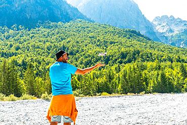 Drone pilot man taking off the drone on the mountain in Valbona natural park on vacation. Albania