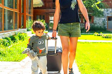 Mother with her son smiling on vacation in a cabin in the mountains, summer rural vacation in nature