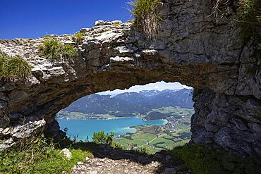 Rock window, view through the Ofenloch on the Bleckwand towards Strobl with Wolfgangsee, Salzkammergut, province of Salzburg, Austria, Europe