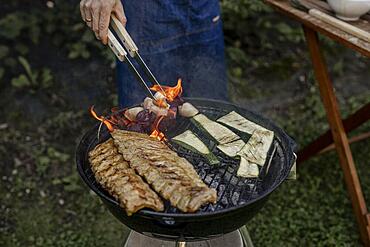 Man barbecuing in the garden