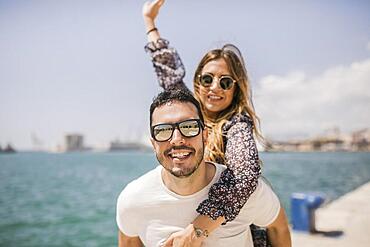 Woman enjoying piggyback ride his boyfriend s back