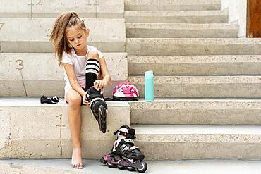 Girl putting black roller blades