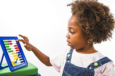 Kid playing with abacus studio