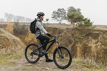 Man riding bike mountain path