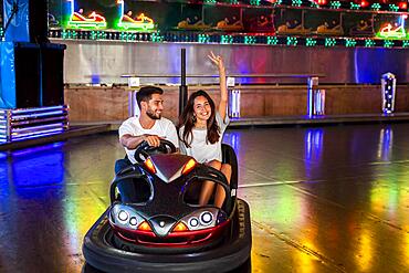 Cute couple having fun bumper cars