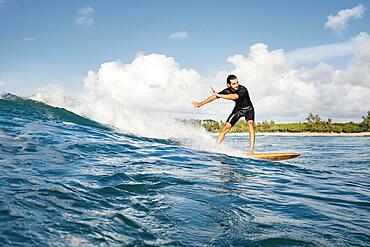 Man riding his surfboard having good time long shot