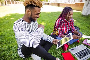 Young black people studying park