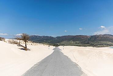 Empty road sands against mountains