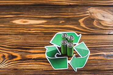 Battery recycle icon wooden textured backdrop