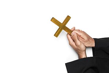 Priest holding holy cross hands