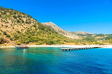 Boat pier at Kakome Beach seen from the boat on the Albanian riviera near Sarande and its turquoise waters, Albania, Europe