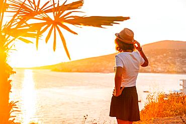 Panoramic view of the city and a tourist woman at sunset of Sarande or Saranda on the Albanian riviera, Albania, Europe