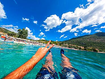 Resting in the sea on the beach in summer of Paralia Mikros Gialos in the south of the island of Lefkada. Greece