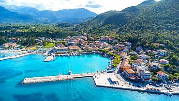 Aerial view of the port of the coastal village of Vasiliki in the south of the island of Lefkada, Greece. Beautiful crystal clear turquoise and blue waters