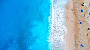 Aerial drone aerial shot in summer on paradise sandy beach Megali Petra in Lefkada. Beautiful crystal clear turquoise and blue waters. Greece