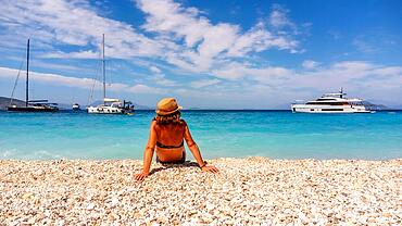 Portrait of a tourist woman resting on the Gidaki Beach on the island of Ithaki or Ithaca in the Ionian sea in the Mediterranean sea of Greece