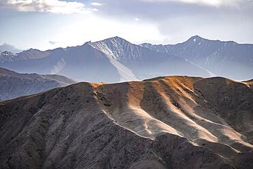 View over eroded mountainous landscape with brown hills, mountains and steppe, Chuy province, Kyrgyzstan, Asia