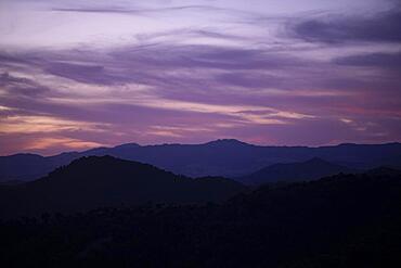 Pink clouded sky with mountains