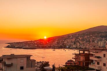 Panoramic view at sunset of the beach and city high above the Albanian Riviera town of Sarande, Albania, Europe